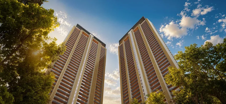 Godrej Verano twin towers seen from the ground against blue sky, Golf Course Extension Road Gurgaon